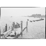Rockaway Beach: Existing conditions, B9 Street looking west, men fishing on pier with rowboats lined up